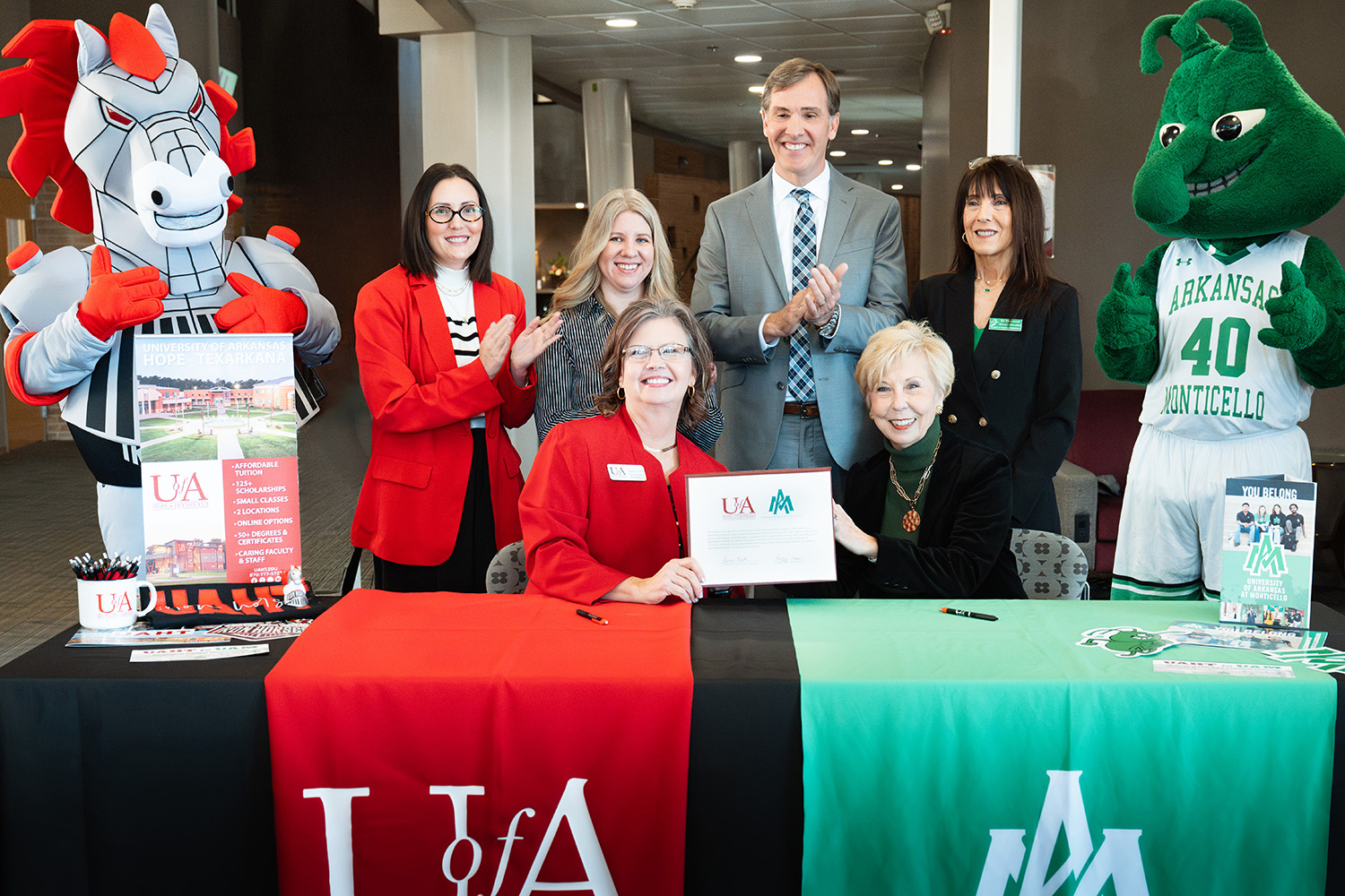Front row left to right: Laura Clark, UAHT interim chancellor and Dr. Peggy Doss, UAM Chancellor.  Back row: Spike the Iron Horse; Dr. Mikki Curtis, UAHT dean of arts, humanities, and education; Jennifer Teresa, UAHT dean of business and technical education; Chris Thomason, UA System VP for strategic and community college partnerships; Dr. Kim Level, UAM dean of education; and Weezy the Weevil.